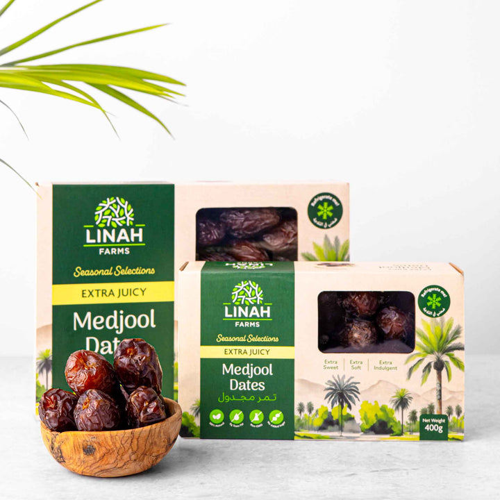 two boxes of Linah Farms' extra juicy medjool dates with a bowl of medjool dates on the side 