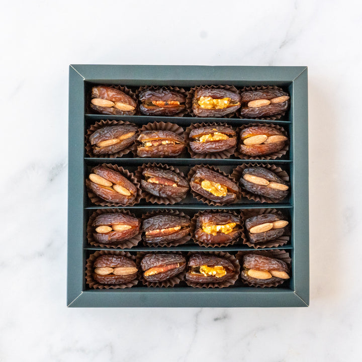 A beautifully arranged Festive Edition box of Medjool dates filled with assorted nuts, styled elegantly for celebrations and special occasions.