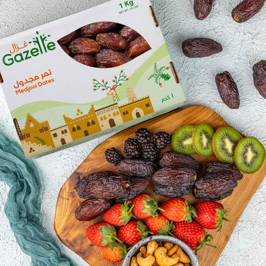 A Pack of Gazelle Medjool dates with a board including some medjool dates, fruits and nuts